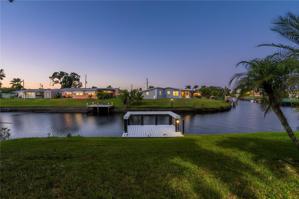 6821 Marius Road North Port, FL 34287 - Photo 36 of 39 a view of a lake with a house in the background