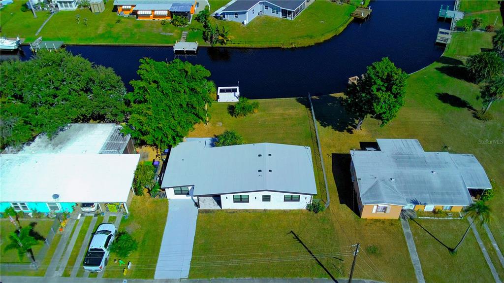 6821 Marius Road North Port, FL 34287 - Photo 38 of 39 an aerial view of a house with a yard and lake view