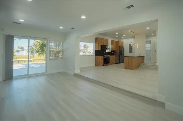 an open space with kitchen view and a window