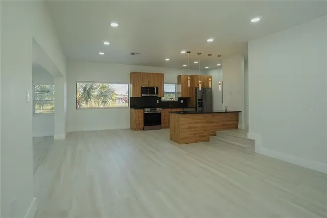 a view of kitchen and hall with wooden floor