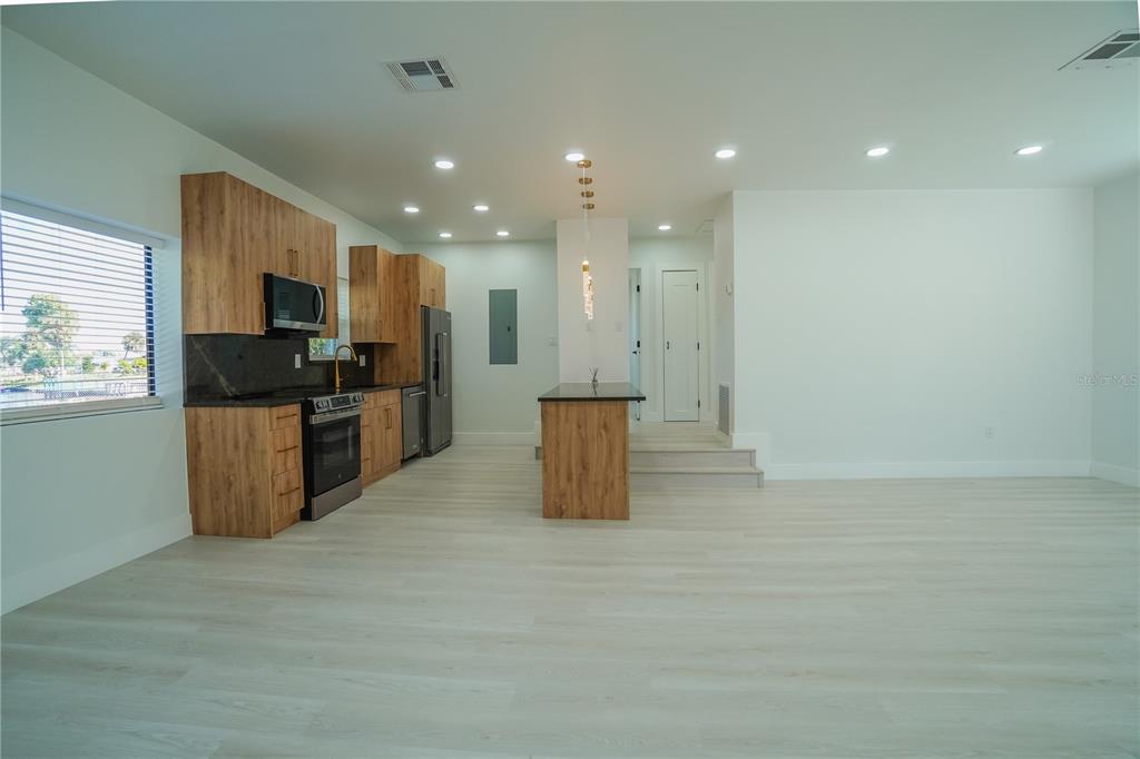 6821 Marius Road North Port, FL 34287 - Photo 7 of 39 a kitchen with a sink and stainless steel appliances