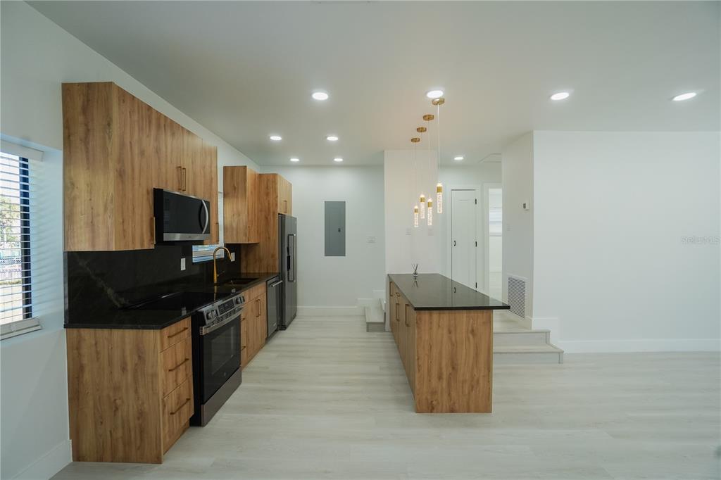 6821 Marius Road North Port, FL 34287 - Photo 8 of 39 a kitchen with stainless steel appliances granite countertop a stove and a refrigerator
