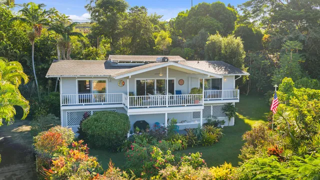 a view of house with a yard
