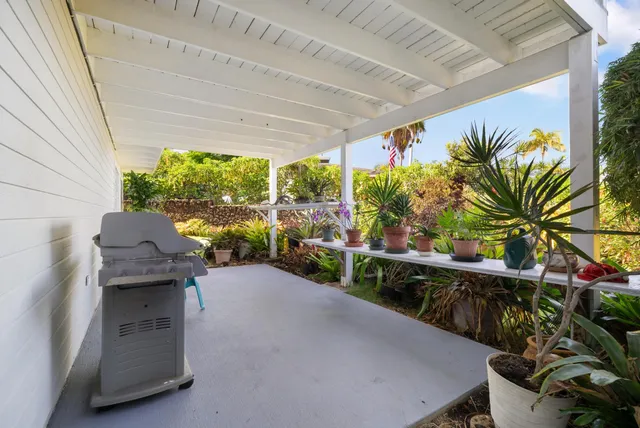 a view of a porch with furniture and a yard