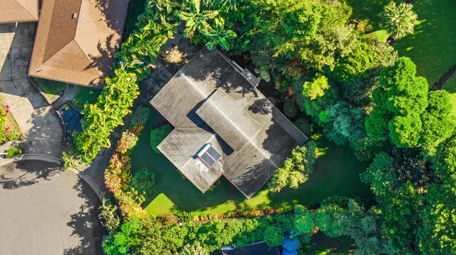 an aerial view of a house with a yard and garden