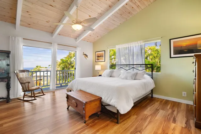 a bed room with a bed and a chair