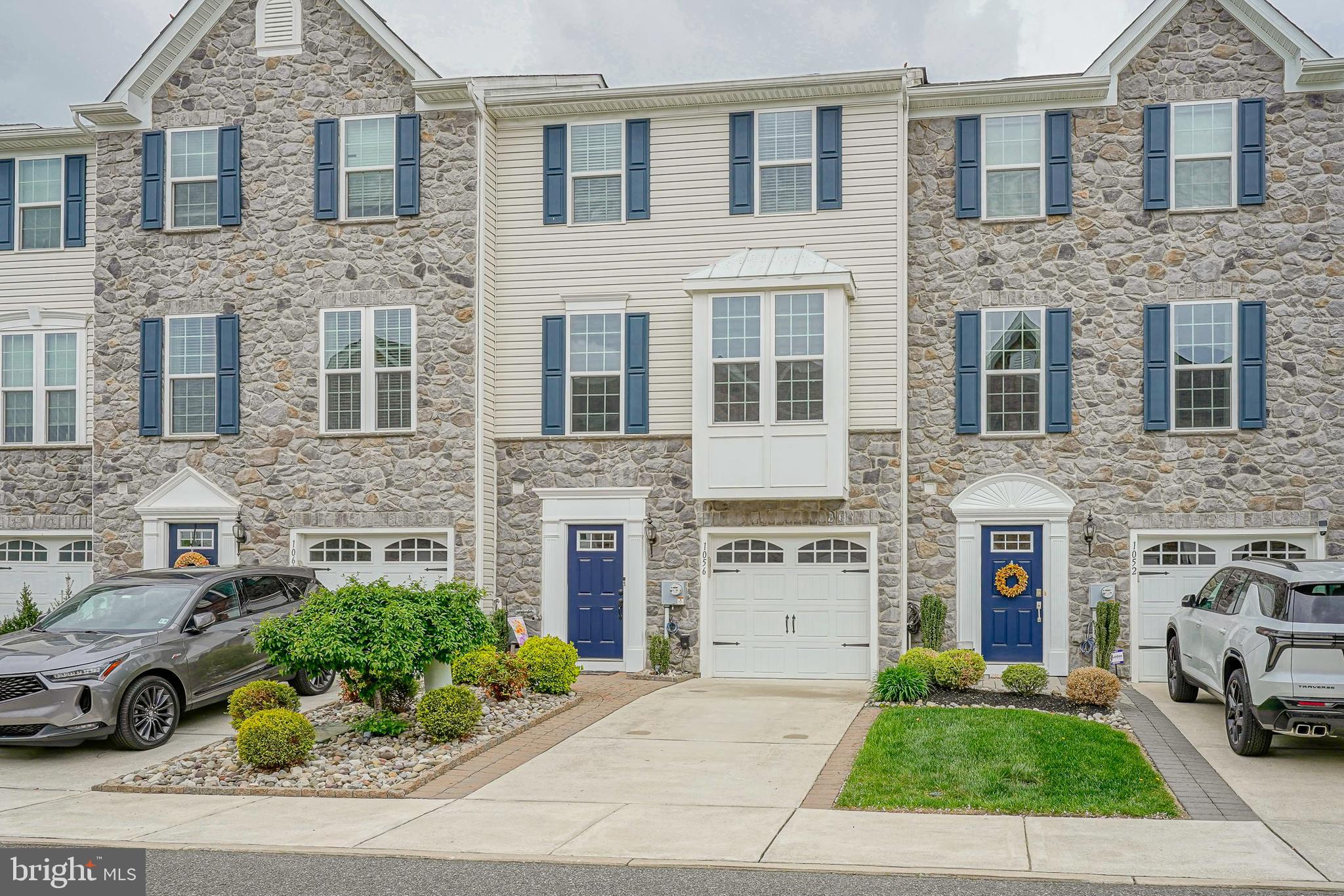 1056 Prime Place Sewell, NJ 08080 - Photo 2 of 41 a front view of a house with a garden and plants