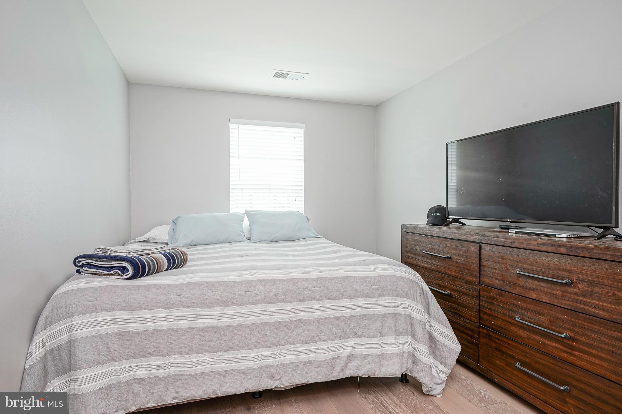 1056 Prime Place Sewell, NJ 08080 - Photo 32 of 41 a bedroom with a bed and a flat screen tv