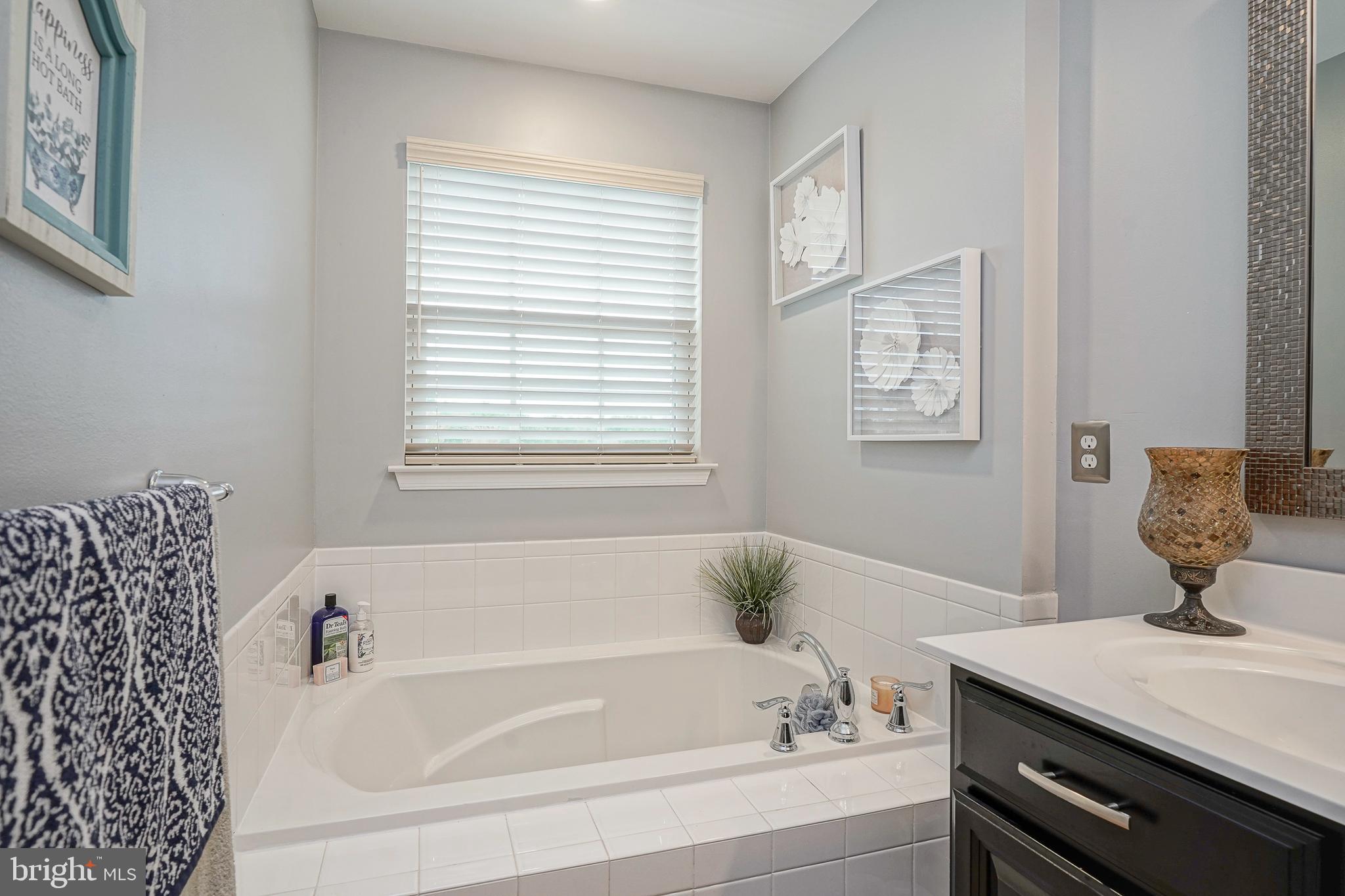 1056 Prime Place Sewell, NJ 08080 - Photo 39 of 41 a bathroom with a bathtub and a window