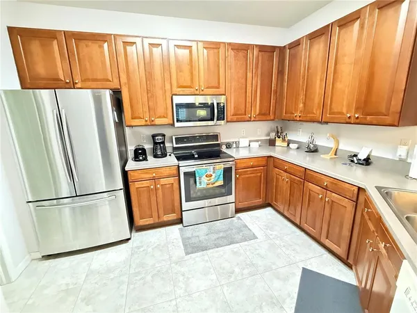 a kitchen with a refrigerator stove and sink