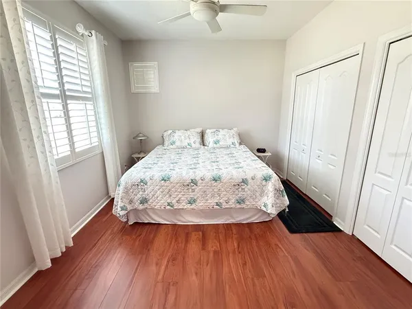 a bed sitting in a bedroom next to a window