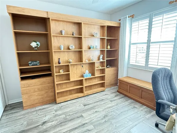 a living room with hard wood floors and window