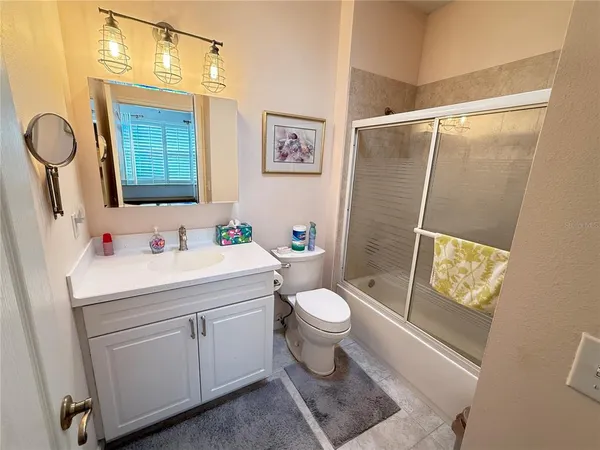 a bathroom with a sink mirror vanity and toilet