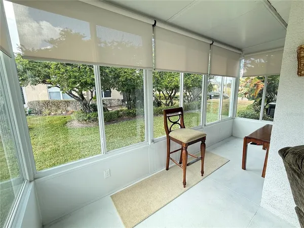 a living room with furniture and a floor to ceiling window