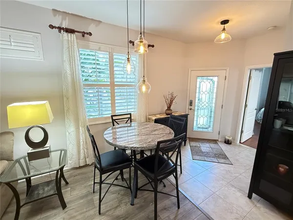 a view of a dining room with furniture and a window