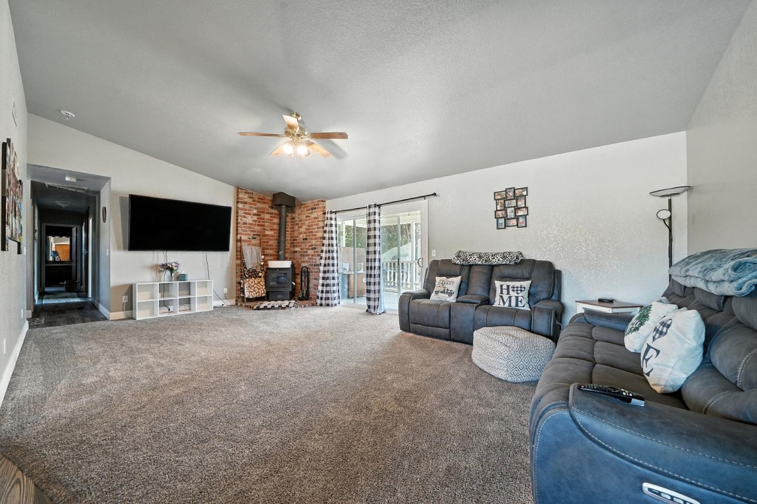 9680 Warren Road Valley Springs, CA 95252 - Photo 15 of 51 a living room with furniture and a flat screen tv