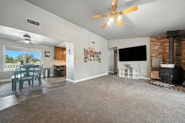 a view of a livingroom with furniture and a flat screen tv