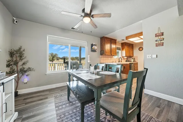 a dining room with furniture window and wooden floor