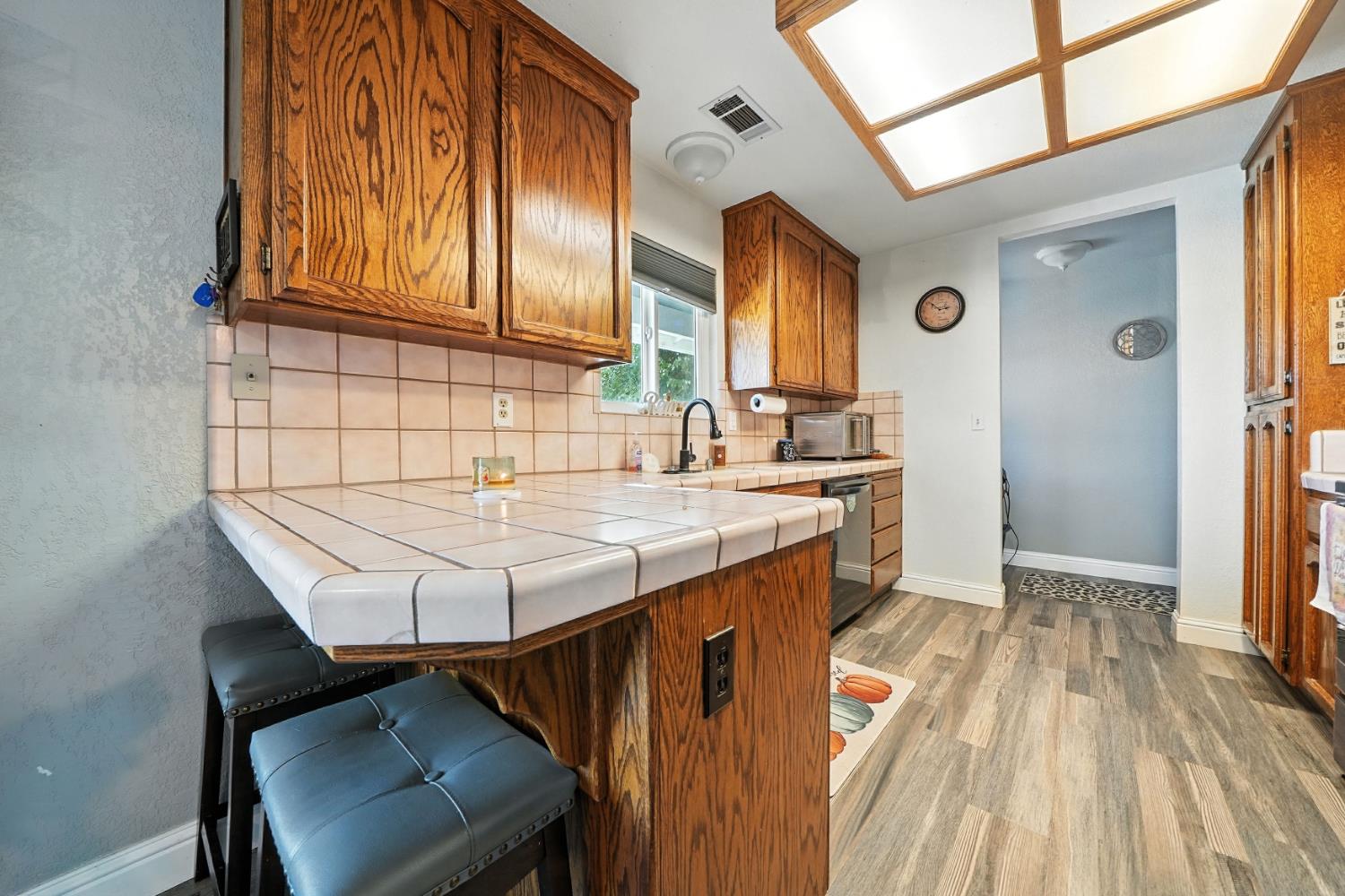 9680 Warren Road Valley Springs, CA 95252 - Photo 22 of 51 a kitchen with a sink a stove and cabinets