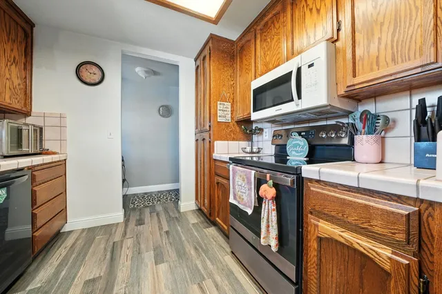a kitchen with stainless steel appliances granite countertop a stove and a refrigerator