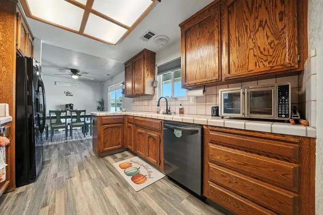 a kitchen with granite countertop stainless steel appliances and wooden cabinets