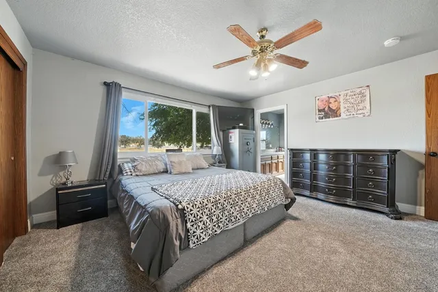 a bedroom with a large bed and a large window