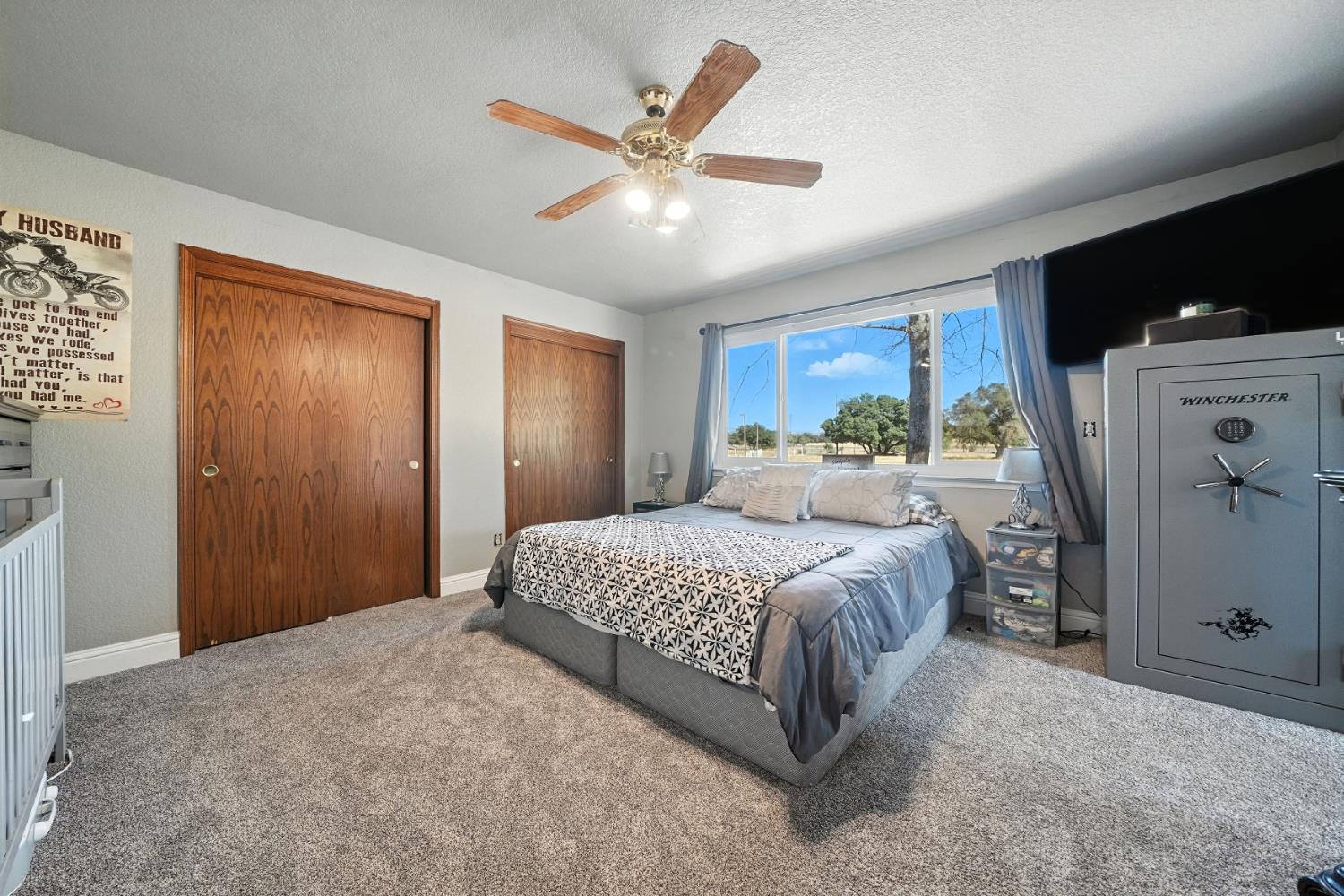 9680 Warren Road Valley Springs, CA 95252 - Photo 30 of 51 a bedroom with a large bed and a large window