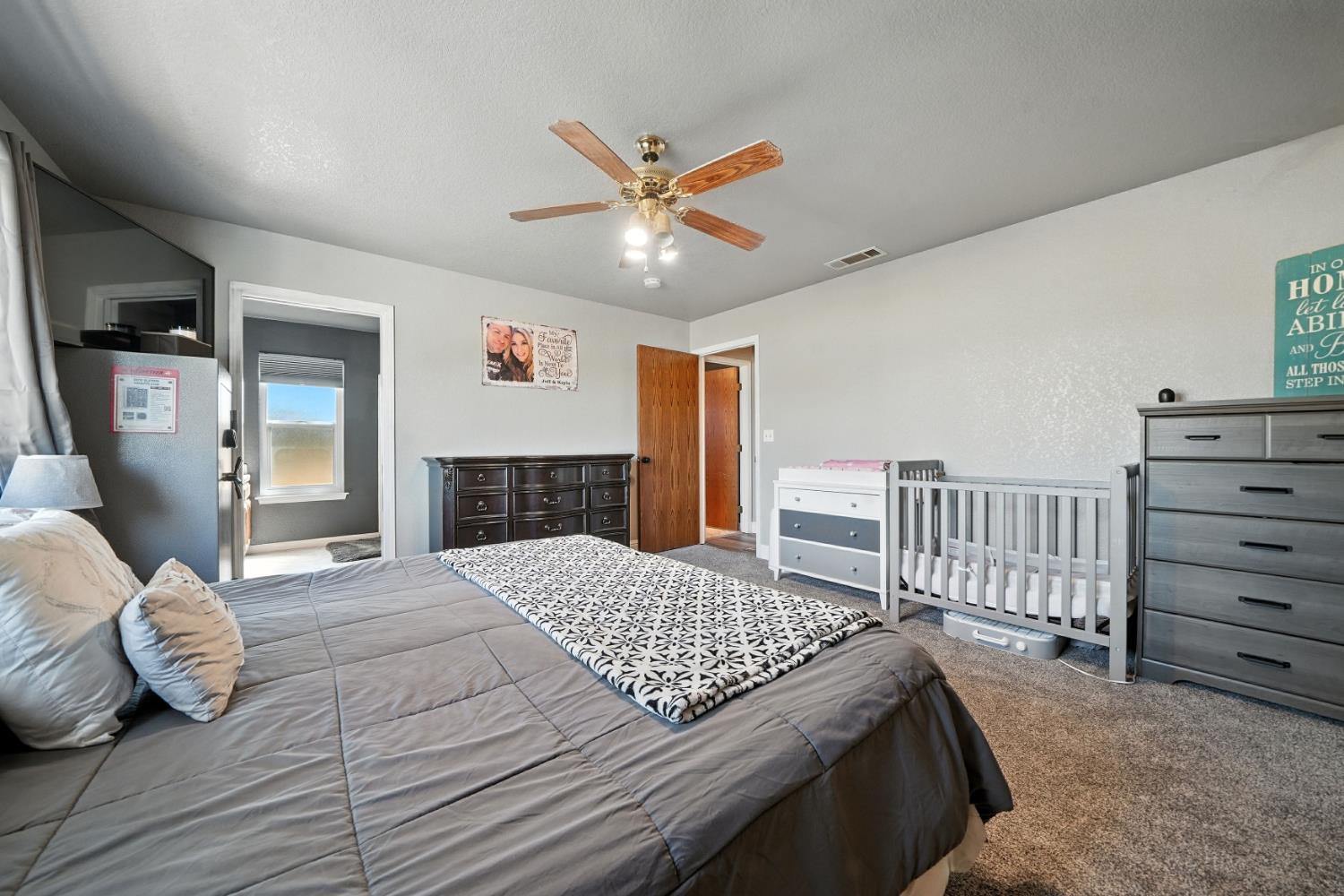 9680 Warren Road Valley Springs, CA 95252 - Photo 31 of 51 a bedroom with a large bed and a chandelier