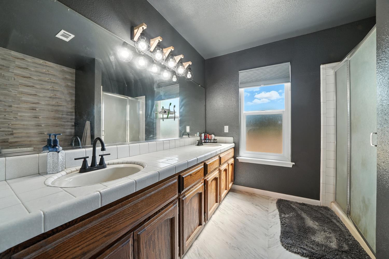 9680 Warren Road Valley Springs, CA 95252 - Photo 32 of 51 a bathroom with a sink and a mirror