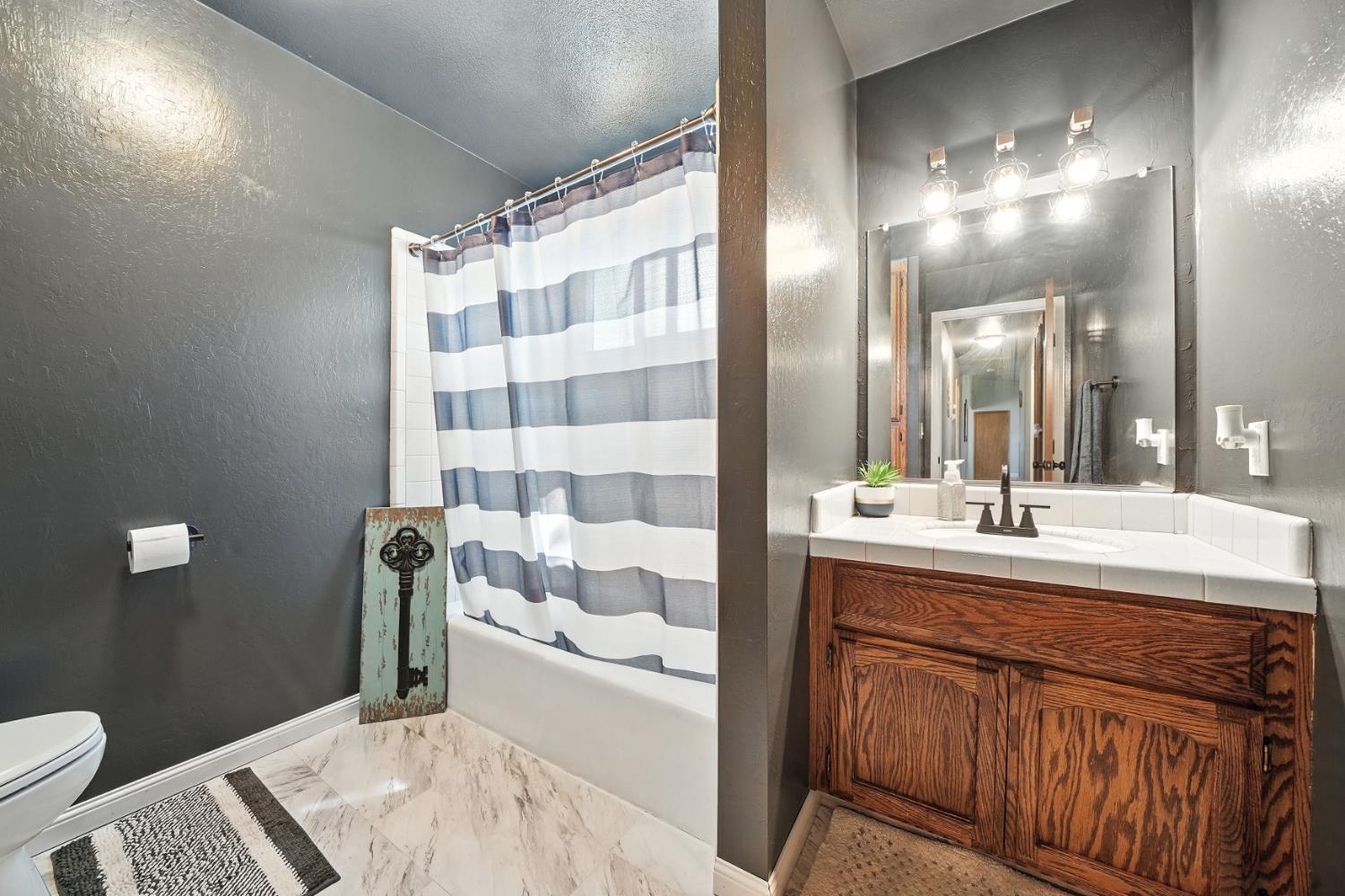 9680 Warren Road Valley Springs, CA 95252 - Photo 35 of 51 a bathroom with a sink and a mirror