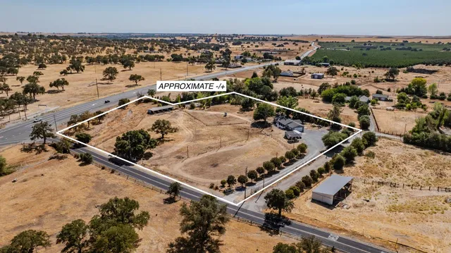 a view of a house with a yard covered in snow