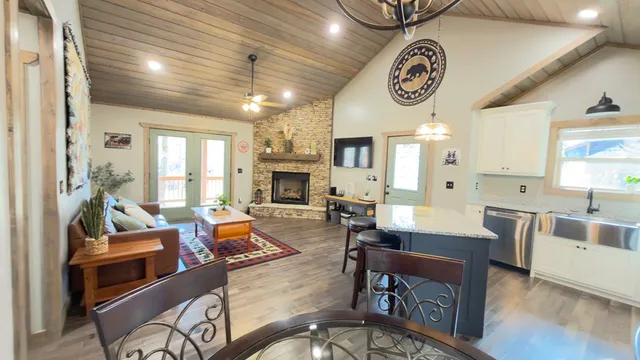 a living room with fireplace furniture and a large window