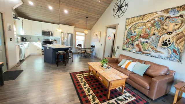 a living room with couches kitchen view and kitchen view