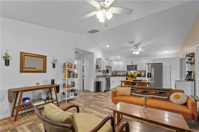 a living room with fireplace furniture and a flat screen tv