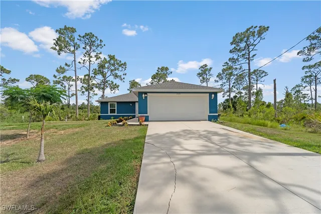 a front view of a house with a yard and a garage