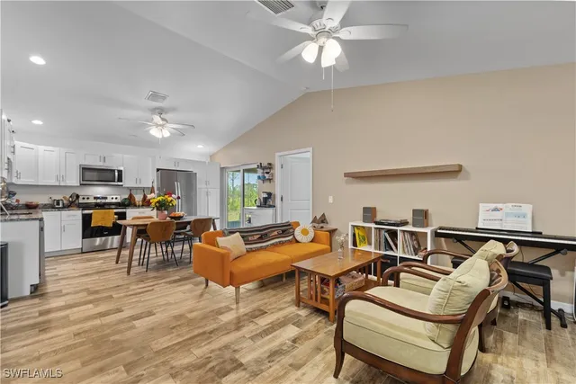 a living room with furniture and kitchen view