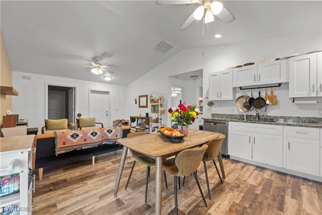 a view of a dining room with furniture and a kitchen