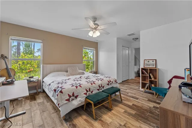 a bedroom with a bed gym equipment and a window