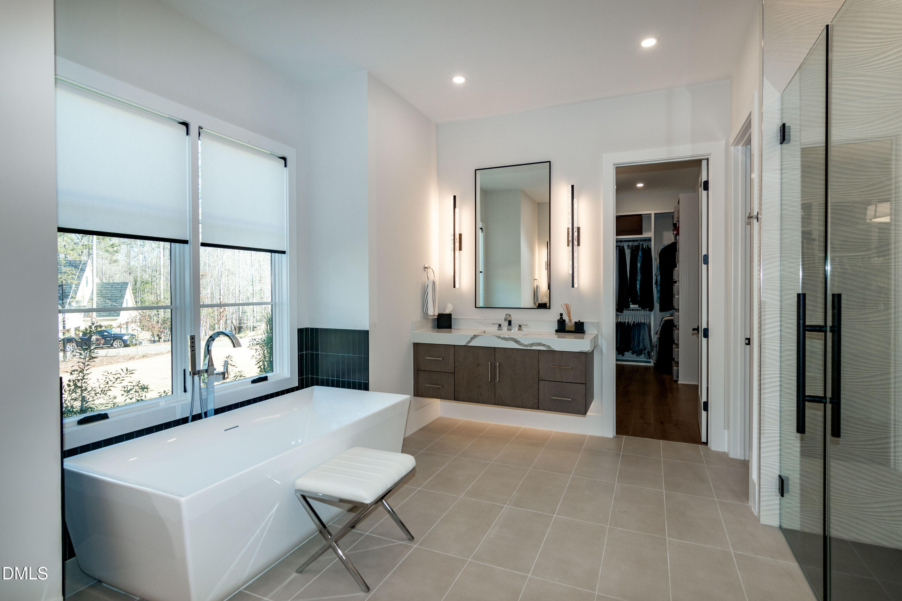 7644 Falls Creek Lane Raleigh, NC 27614 - Photo 30 of 58 a large en suite bathroom with a tub shower and sink