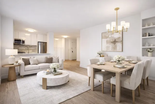 a living room with furniture and a chandelier