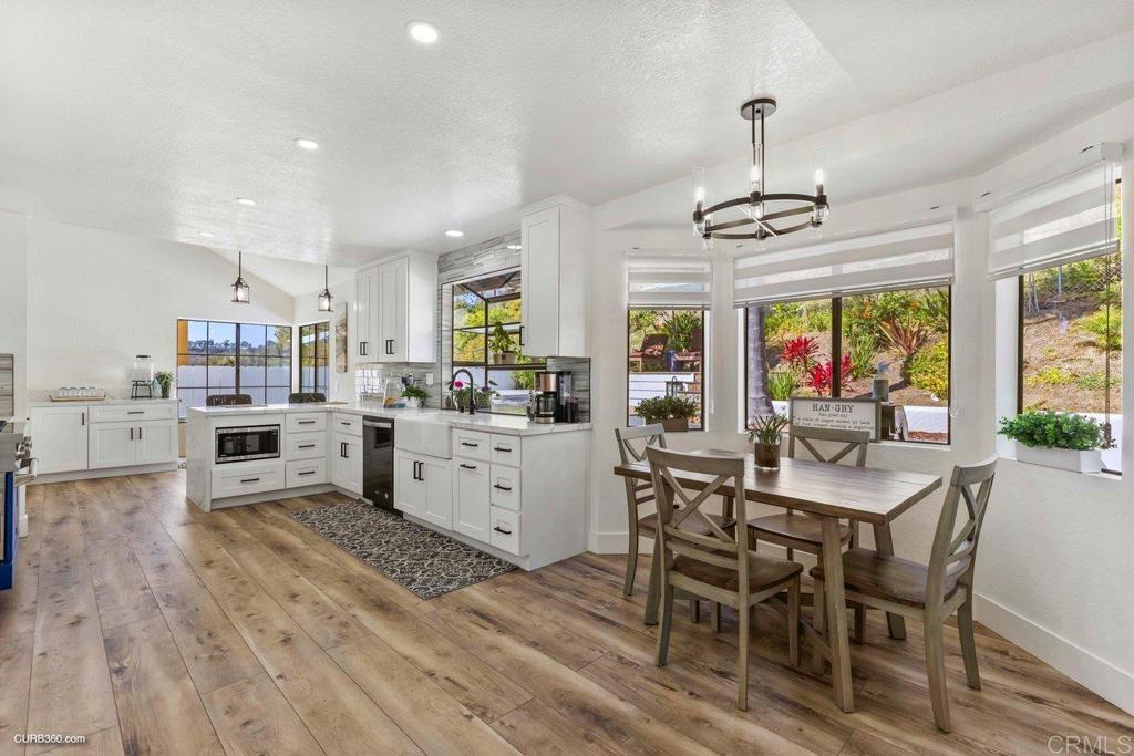 1618 Buttercup Road Encinitas, CA 92024 - Photo 14 of 33 a view of a dining room and livingroom with furniture wooden floor a chandelier