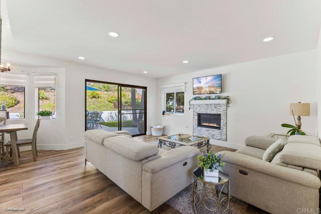 1618 Buttercup Road Encinitas, CA 92024 - Photo 16 of 33 a living room with furniture a large window and a fireplace