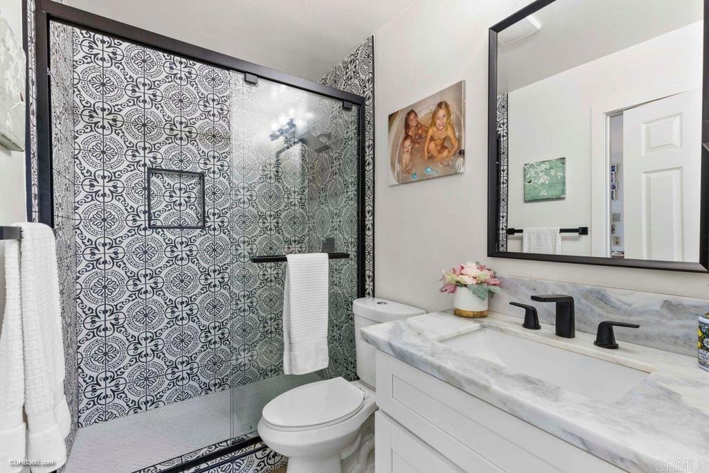 1618 Buttercup Road Encinitas, CA 92024 - Photo 19 of 33 a bathroom with a toilet sink and mirror