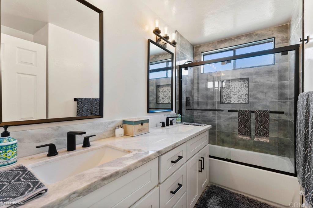 1618 Buttercup Road Encinitas, CA 92024 - Photo 28 of 33 a bathroom with a granite countertop sink mirror and double