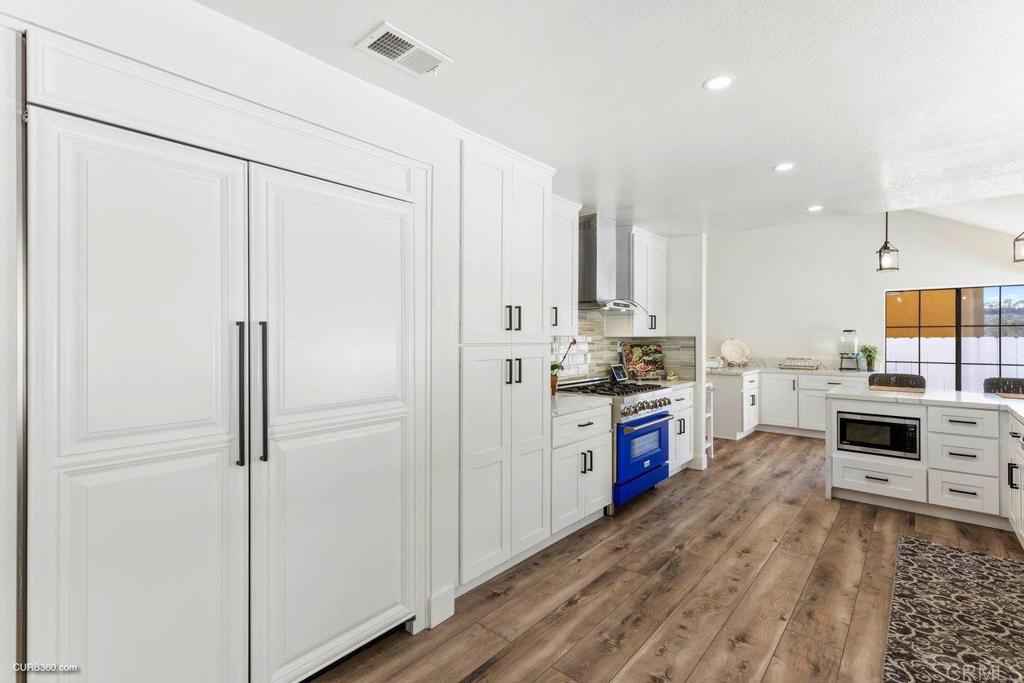 1618 Buttercup Road Encinitas, CA 92024 - Photo 5 of 33 a kitchen with stainless steel appliances a refrigerator sink and stove top oven