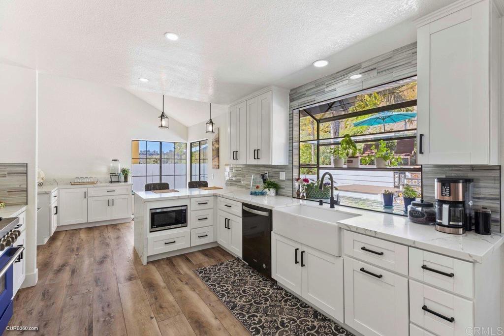 1618 Buttercup Road Encinitas, CA 92024 - Photo 6 of 33 a kitchen with white cabinets and white appliances