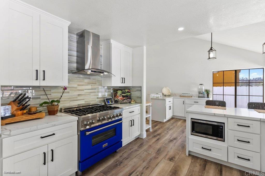 1618 Buttercup Road Encinitas, CA 92024 - Photo 9 of 33 a kitchen with a stove a sink and a refrigerator