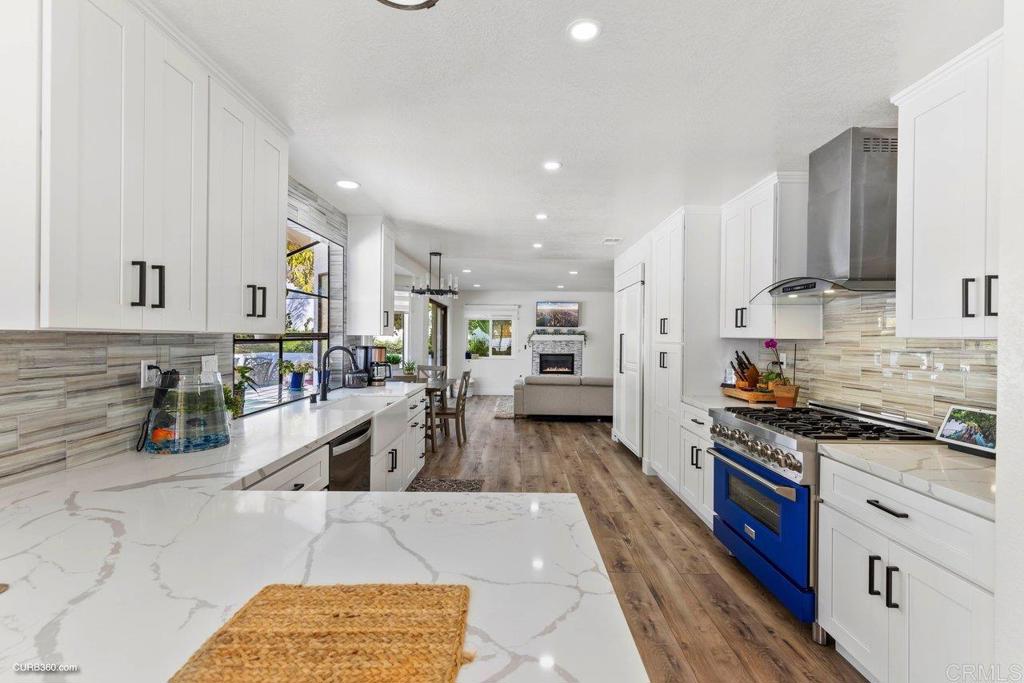 1618 Buttercup Road Encinitas, CA 92024 - Photo 10 of 33 a kitchen with stainless steel appliances granite countertop a sink stove and refrigerator