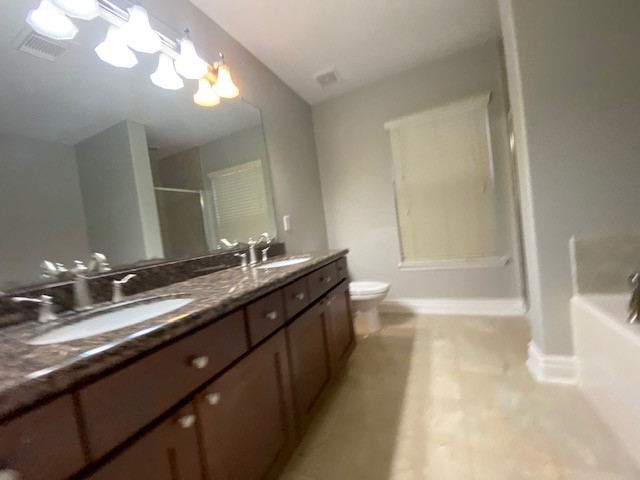 3415 Clearview Circle Houston, TX 77025 - Photo 11 of 16 a bathroom with a double vanity sink a toilet and bathtub