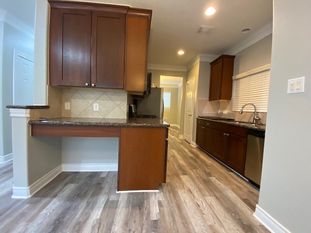 3415 Clearview Circle Houston, TX 77025 - Photo 8 of 16 a kitchen with granite countertop wooden cabinets and stainless steel appliances